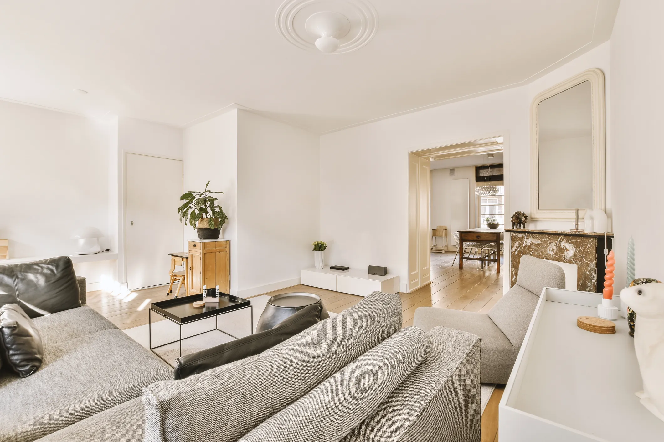 Living room opening through a wide cased doorway to a dining room beyond