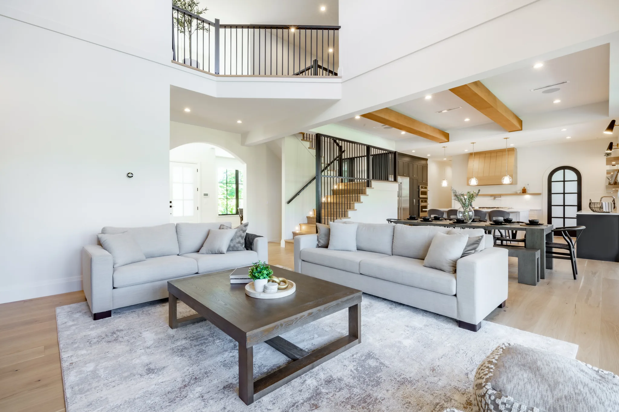 Home remodeling in Hyattsville, MD: open living room and kitchen with an upper landing and exposed beams