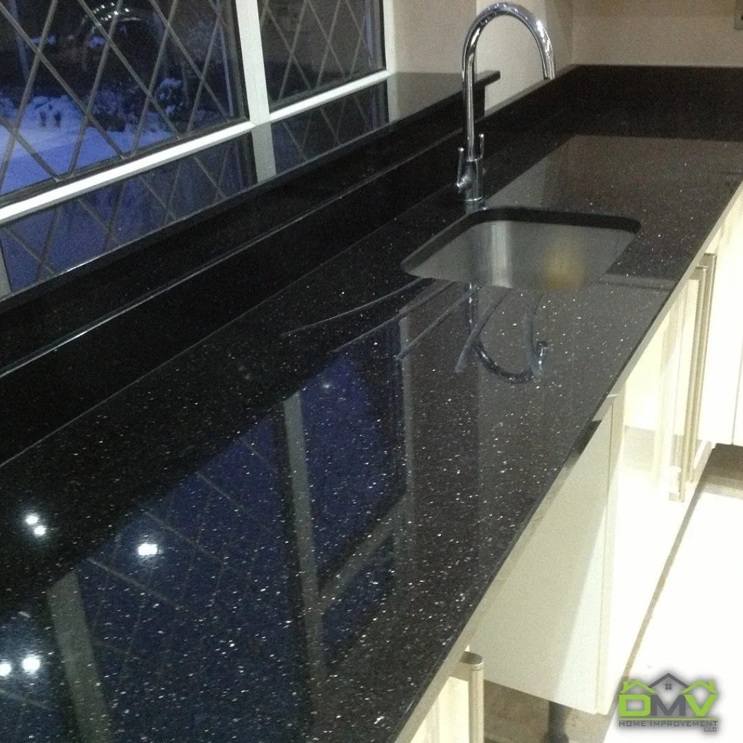 Black granite countertop with an undermount sink and a gooseneck faucet