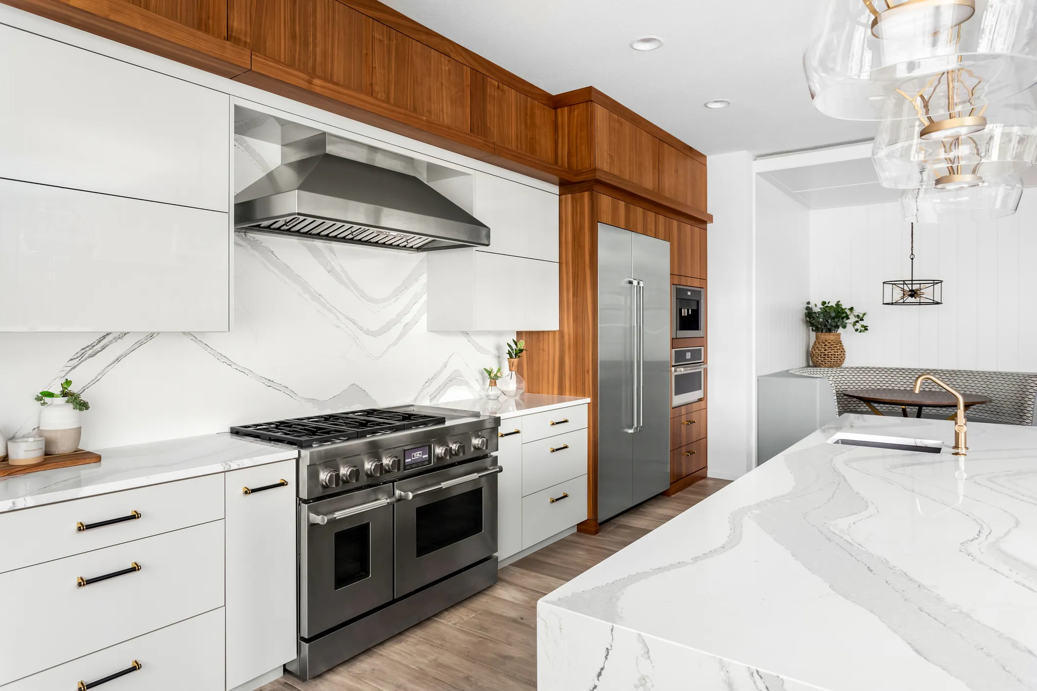 Luxury kitchen renovation with marble countertops and professional range by DMV Home Improvement